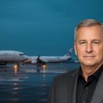 Boeing Orders surge as new 737 MAX and 787 Dreamliner jets line up on a wet airport tarmac at dusk.