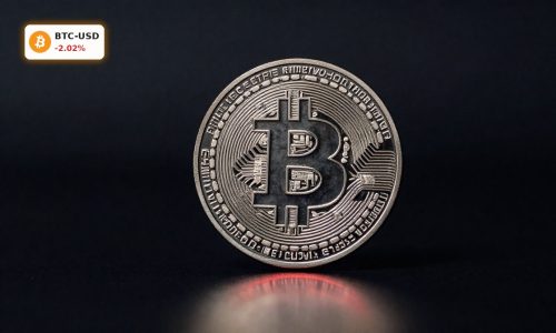 Bitcoin Plunge symbolized by a physical Bitcoin coin on dark background amid red market-stress lighting