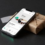 Etsy Earnings optimism shown by smartphone app and parcel symbolizing rising marketplace profits