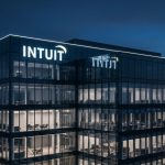 Intuit corporate headquarters building at dusk, highlighting the Intuit Rating and stock downgrade.
