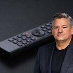 Netflix Merger concept with streaming remote and TV glow, highlighting Netflix buyback shift after merger exit