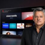 Netflix Merger focus on Netflix streaming app displayed on a smart TV in a dark premium studio setting