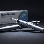 Novo Nordisk Wegovy injection pen on dark background amid obesity drug rivalry and pipeline pressure
