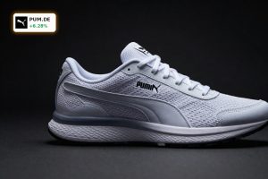 Premium Puma sneakers spotlighted against dark backdrop amid Puma Acquisition takeover speculation