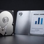 Seagate Convertible Notes concept with Seagate HAMR hard drive and bond certificate on dark studio background