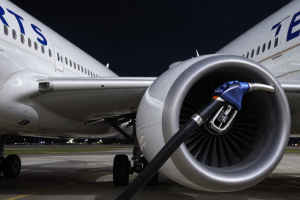United Airlines Oil Shock visualized by jet fuel hose connected to aircraft engine, symbolizing rising fuel costs and margin pressure