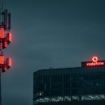 Vodafone telecom tower and Vodafone headquarters at dusk