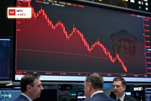 Wells Fargo Earnings reaction with WFC stock chart turning lower on margin concerns in a modern trading floor setting.