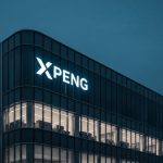 XPeng MONA L03 manufacturer headquarters with glowing logo at dusk